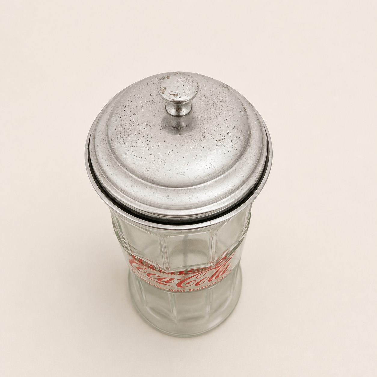 Top-down view of the domed metal lid showing age spotting