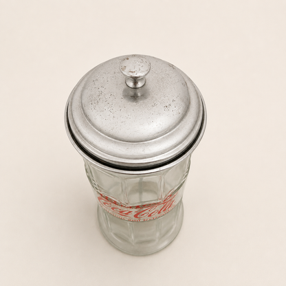 Top-down view of the domed metal lid showing age spotting