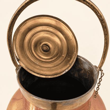 Brass base and underside of the copper ewer