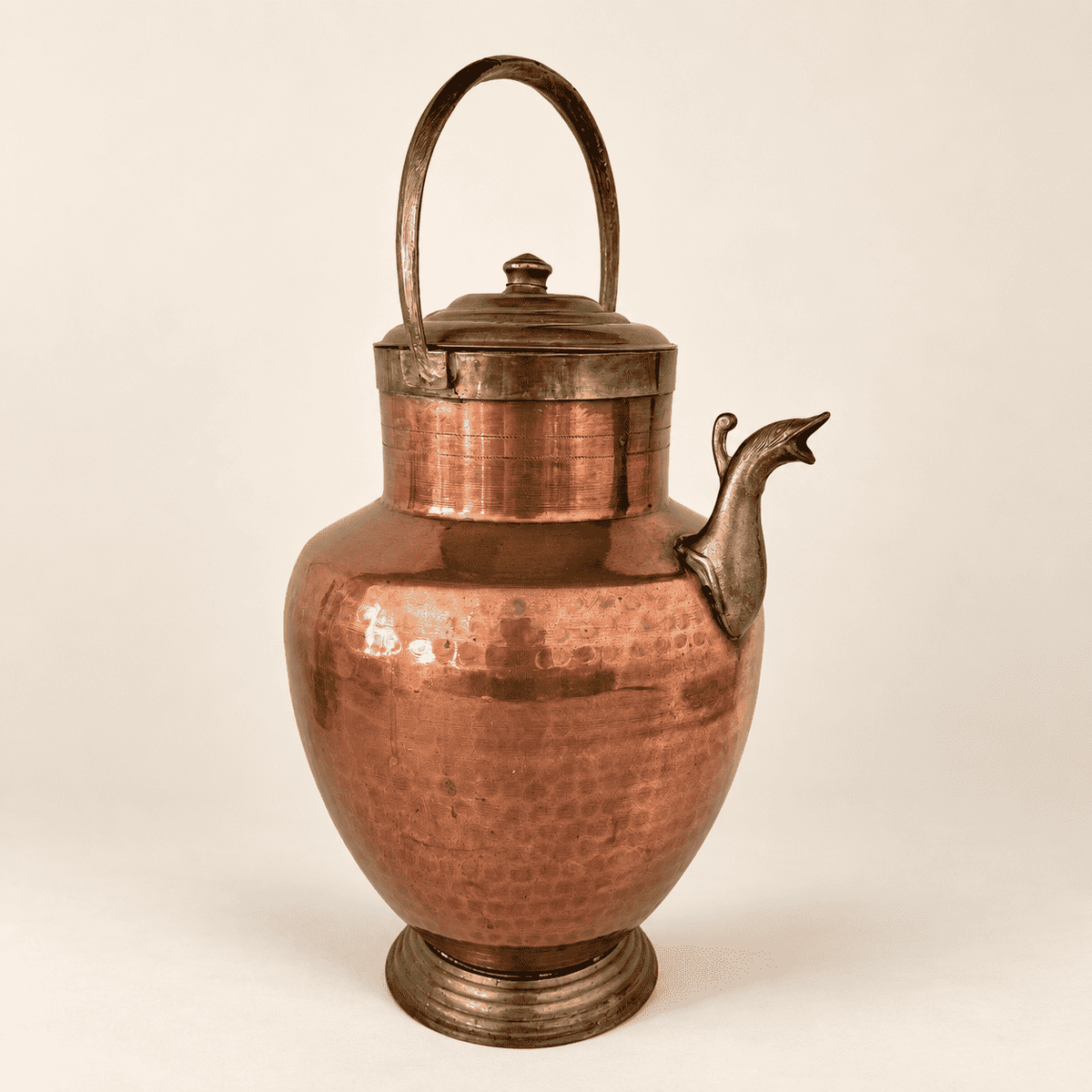 Large hammered copper and brass ewer with bird-head spout, front view