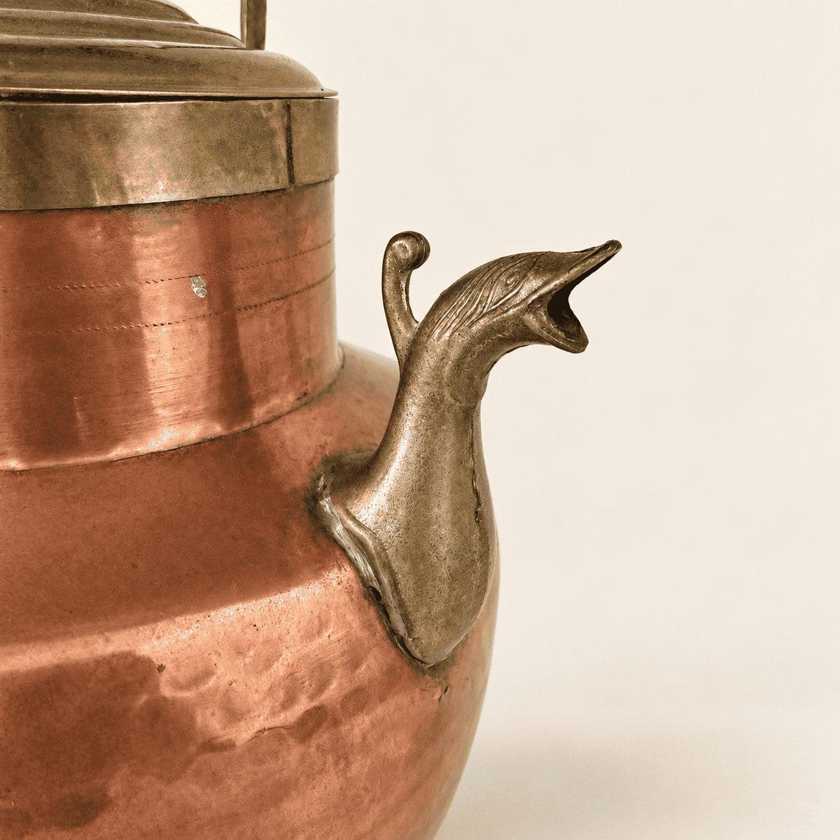 Copper and brass ewer straight on, domed brass lid and carry handle