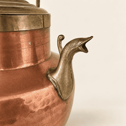 Copper and brass ewer straight on, domed brass lid and carry handle