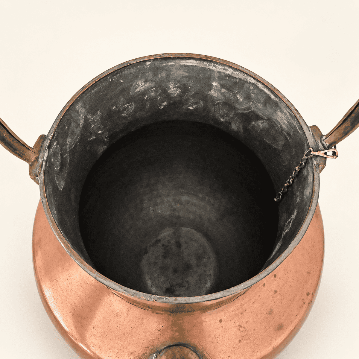Looking down into the tin-lined interior of the copper ewer