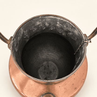 Looking down into the tin-lined interior of the copper ewer