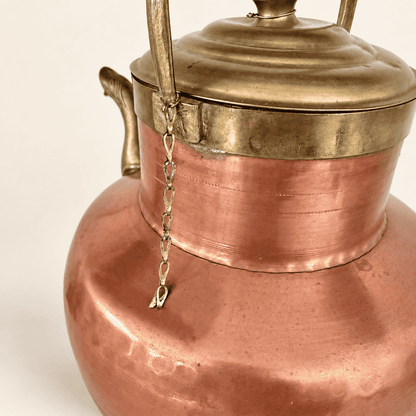 Underside of the brass lid and the small tether chain