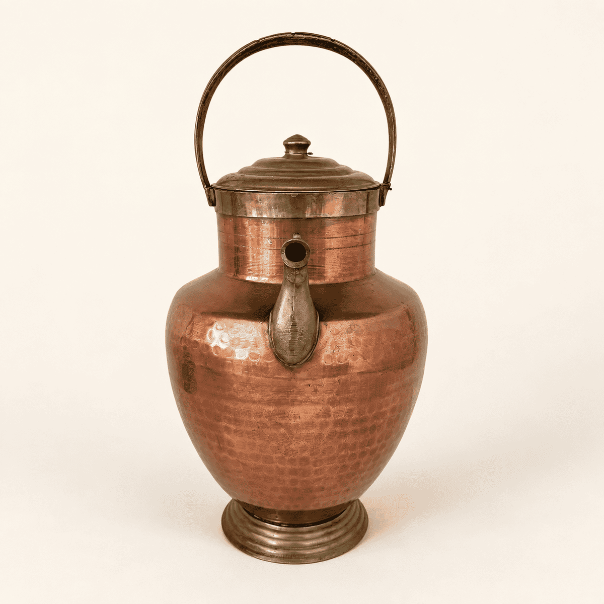Top of the ewer showing the ribbed brass lid, finial, and carry handle