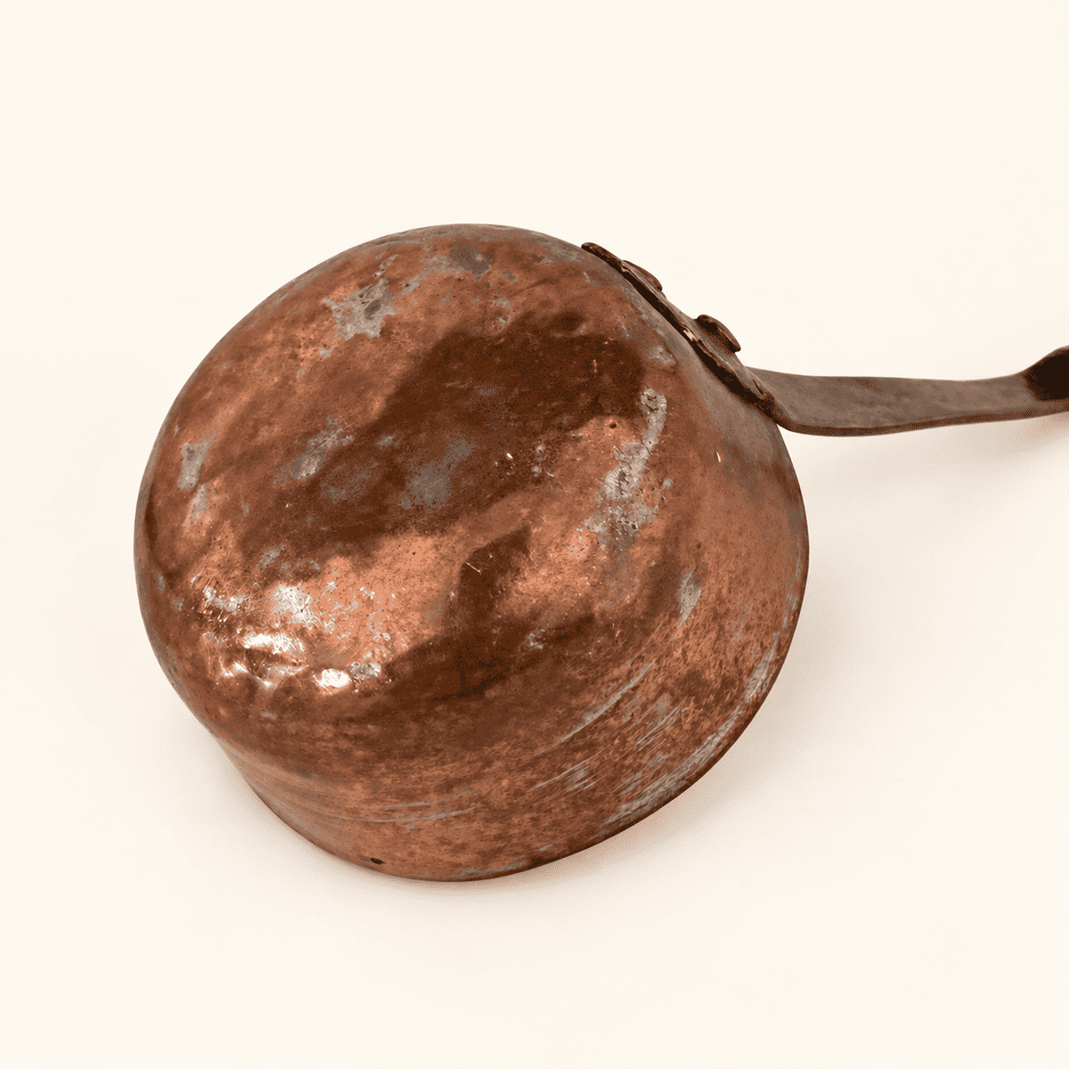 Rounded hand-forged base of the copper dipper bowl with hammer marks