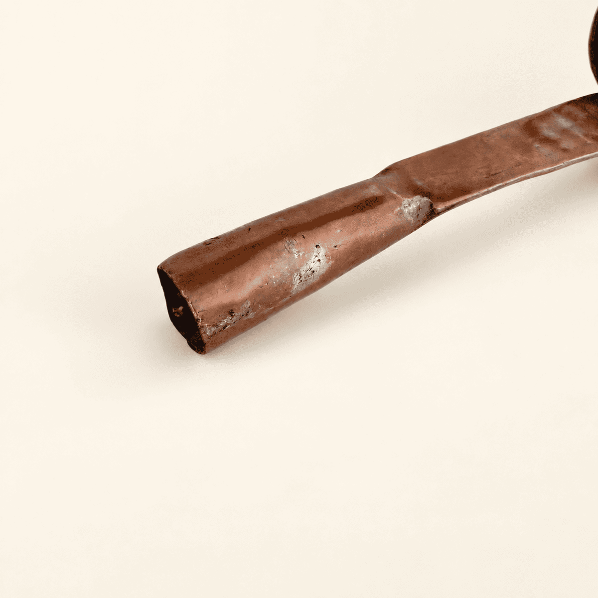 Rolled tubular end of the dipper's forged copper handle