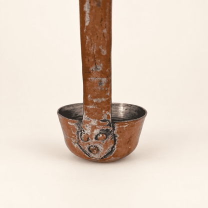 Copper rivets fastening the flat forged handle to the bowl of the dipper