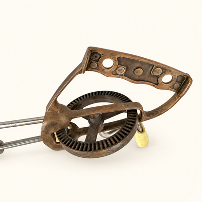 Toothed cast gear wheel and copper handle frame, close detail