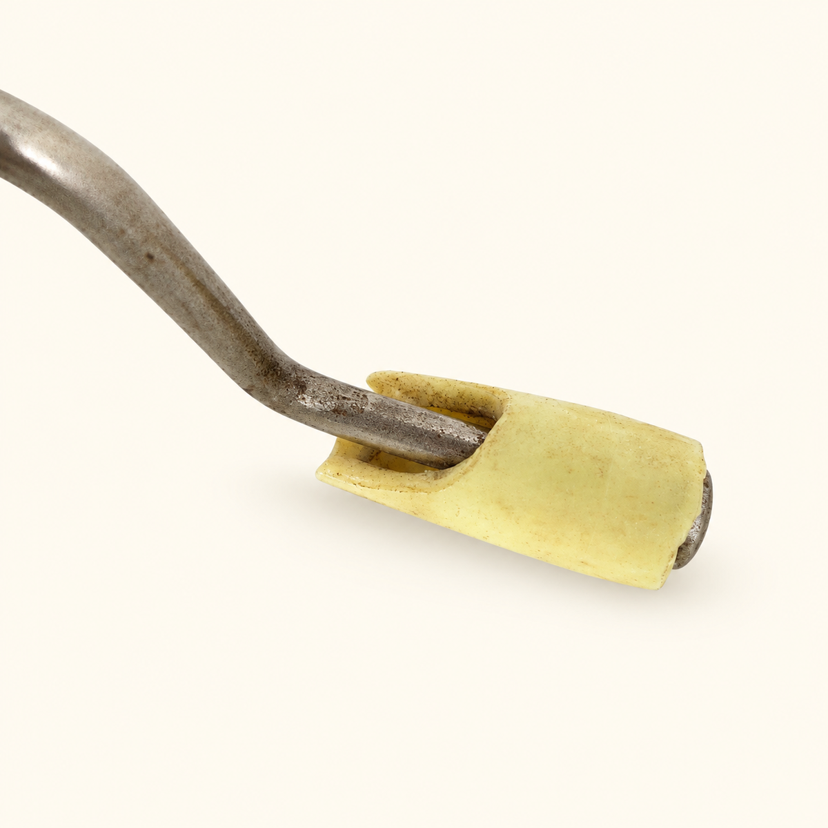 Close detail of the cream turning knob on the bent-steel crank