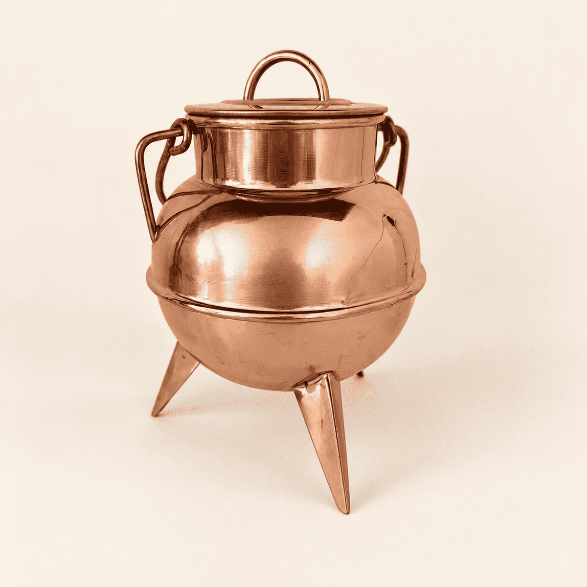 Copper footed cauldron straight on, lid and loop finial