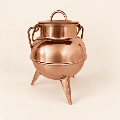 Copper footed cauldron straight on, lid and loop finial