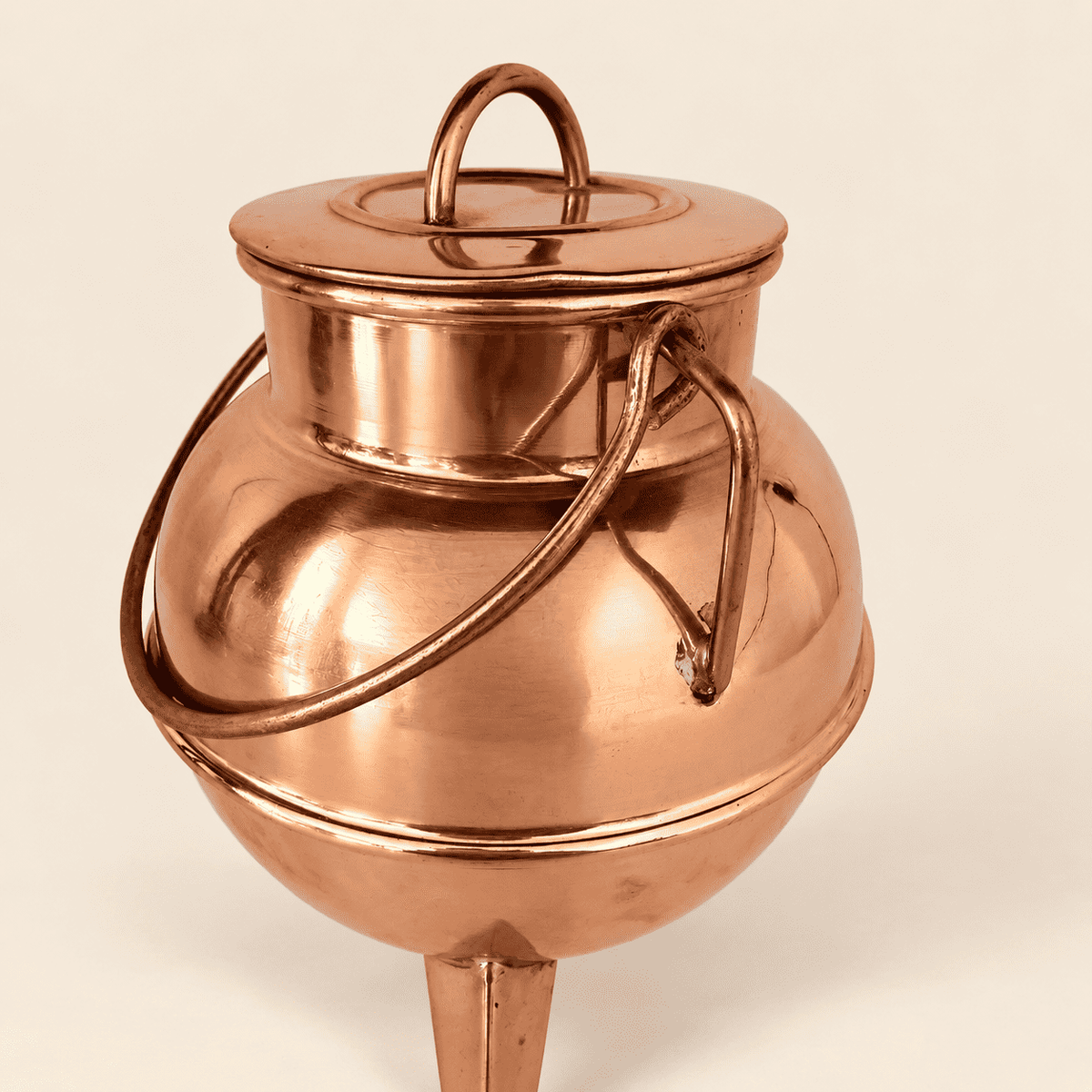 Loop finial on the lid and copper swing bail, close detail