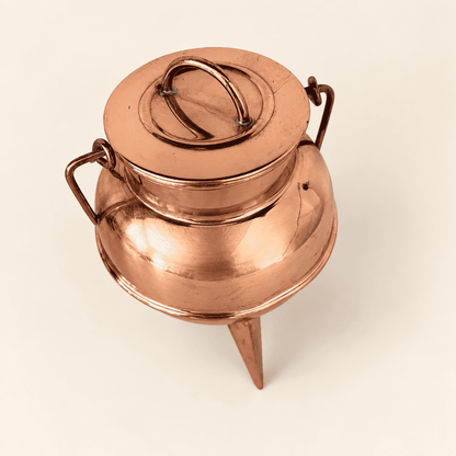 Top view of the copper cauldron lid with the swing bail to one side