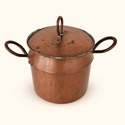 Copper lidded pot from above at an angle, loop-finial lid and two upright handles