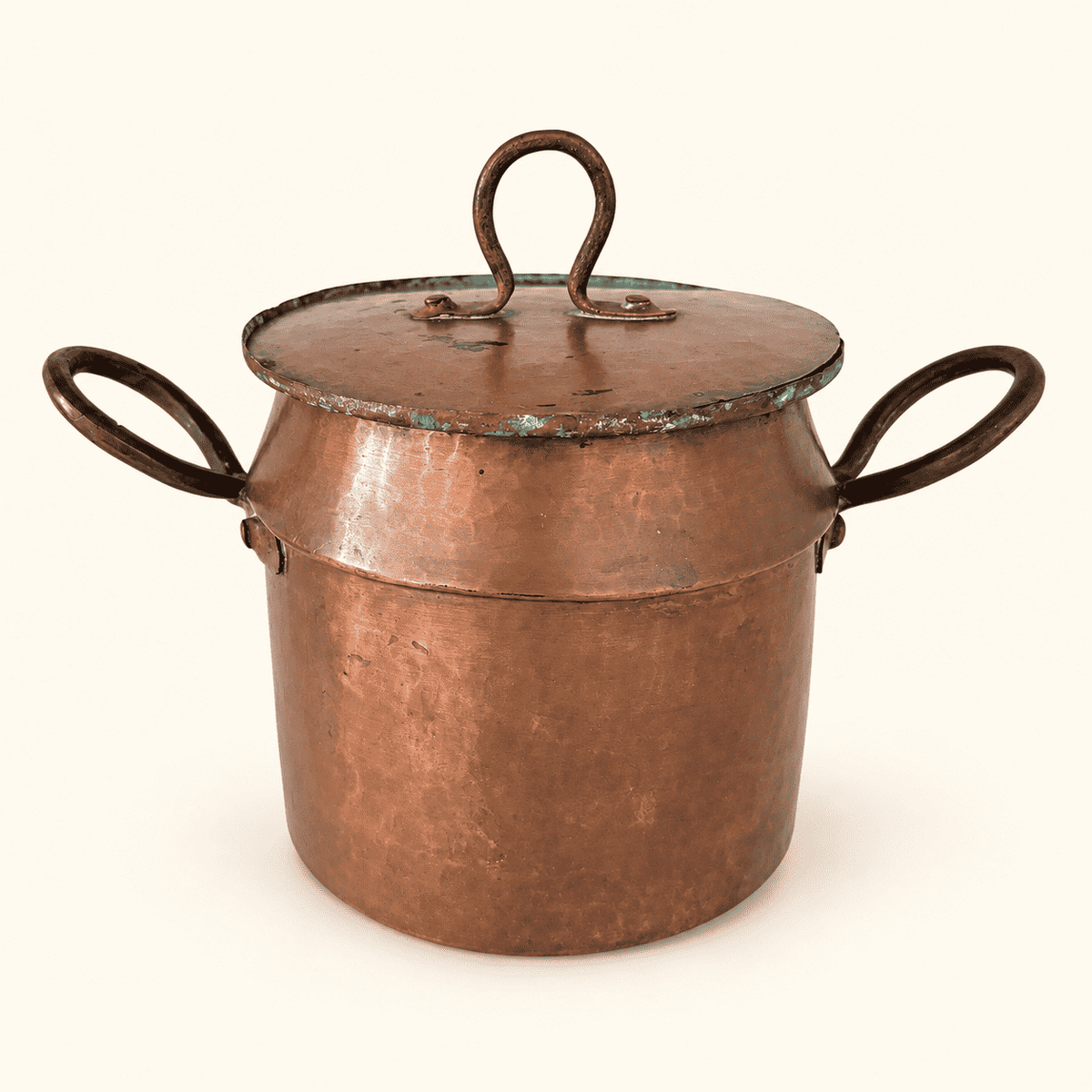 Copper lidded pot straight on, loop finial and both handles, hammered body