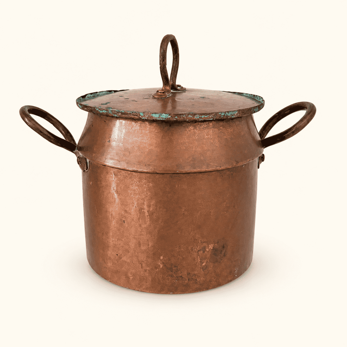 Antique hand-forged copper pot with two loop handles and a lift-off lid, front view