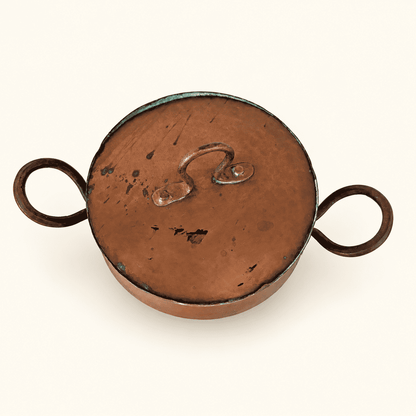 Top of the lift-off lid showing the riveted loop finial and verdigris on the rim