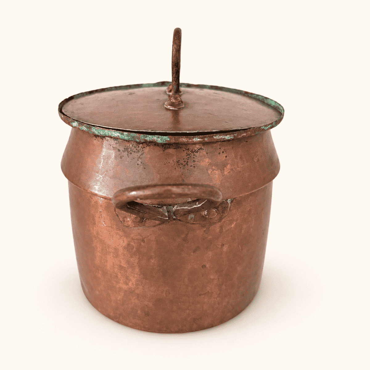 The copper pot from the other side, lid loop finial leaning to one side