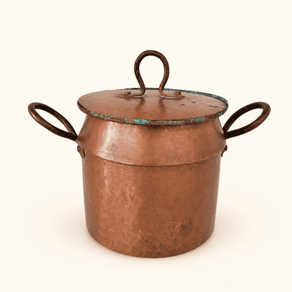 Three-quarter view of the copper pot with the loop finial upright on the lid