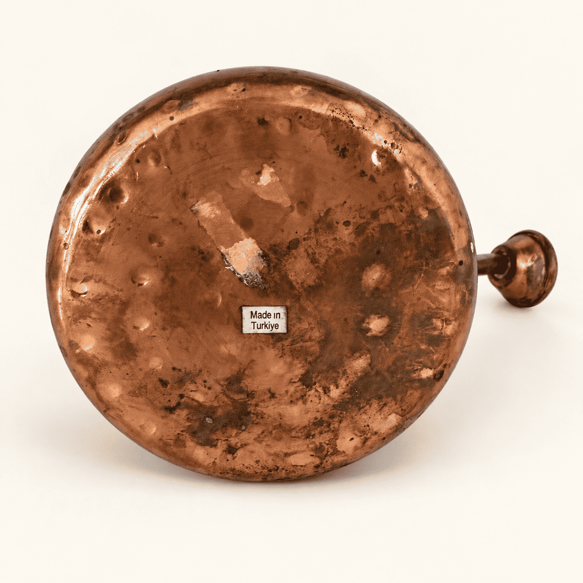 Base of the copper watering can with the Made in Turkiye label