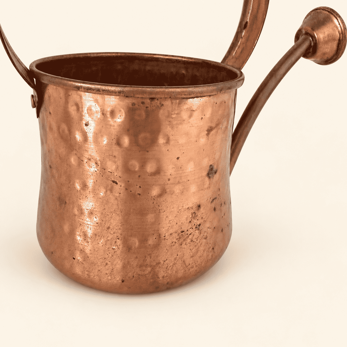 Close view of the hammered copper surface and spout join