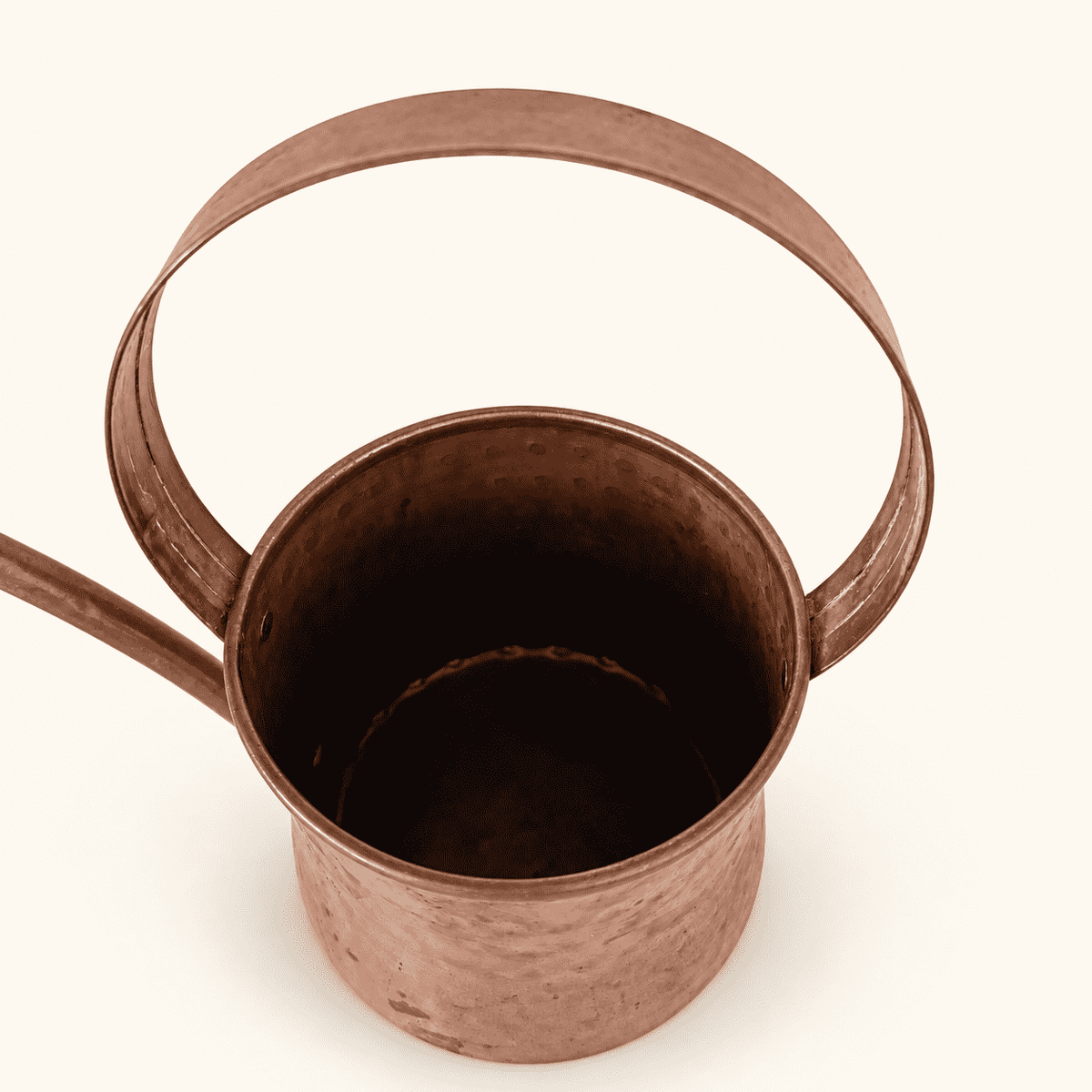 Top view of the copper watering can showing the open top and arched handle