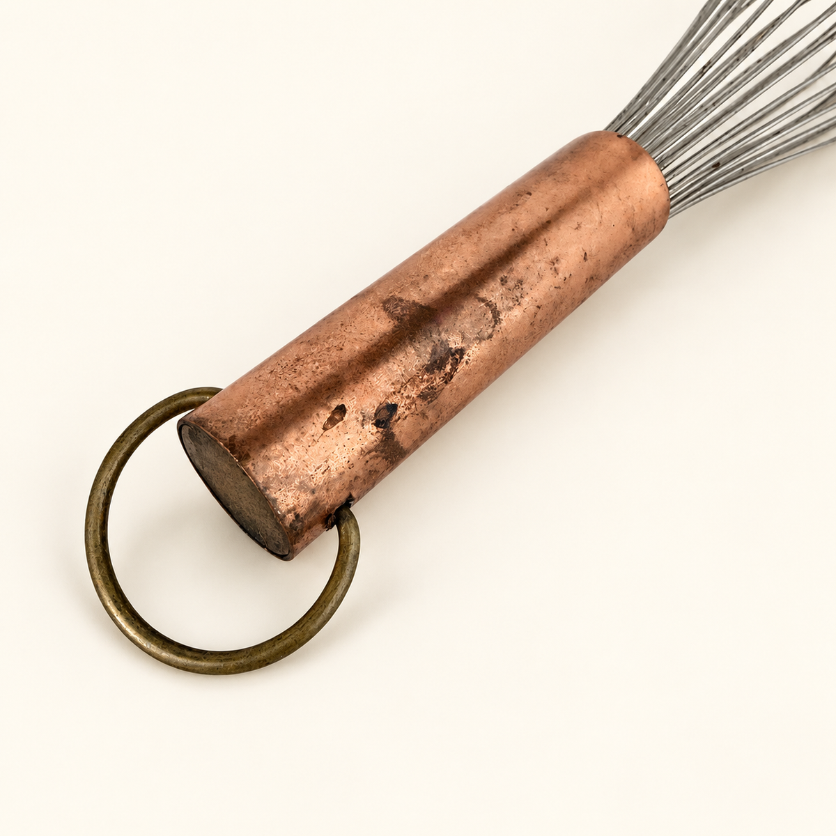 Copper handle end with the brass hanging ring and worn patina, close detail
