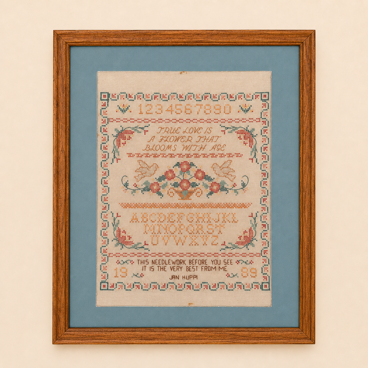 Framed cross stitch sampler with true love verse, doves, and floral basket