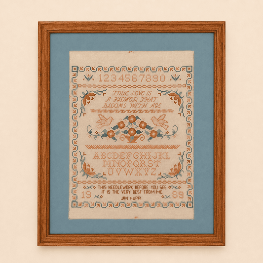 Framed cross stitch sampler with true love verse, doves, and floral basket