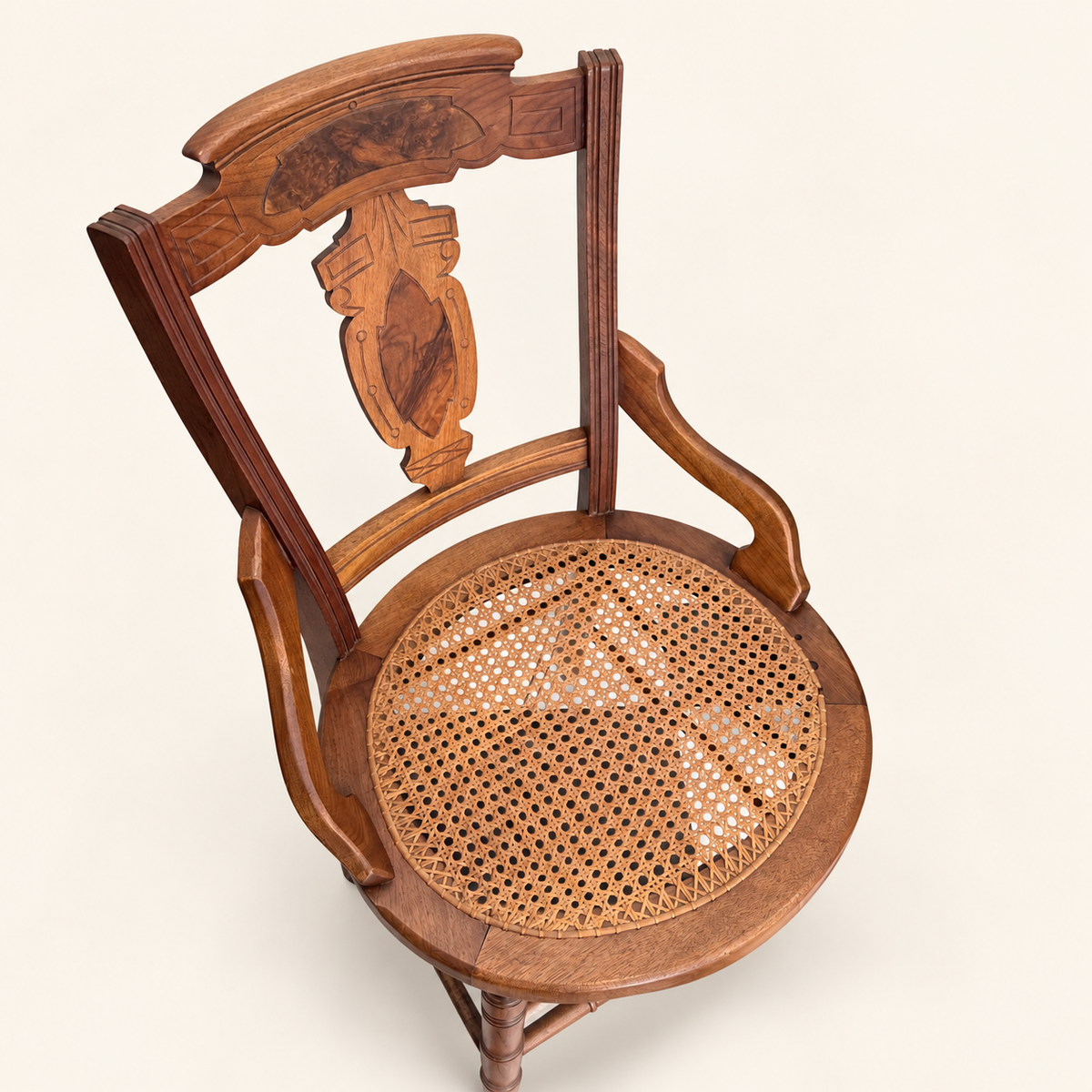 Carved crest and burl walnut panel on Eastlake chair