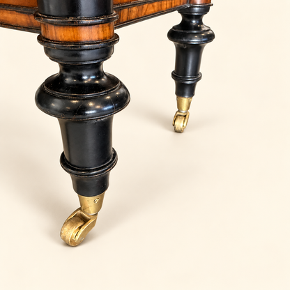 Turned ebonized feet with original brass casters on Edwardian bookcase