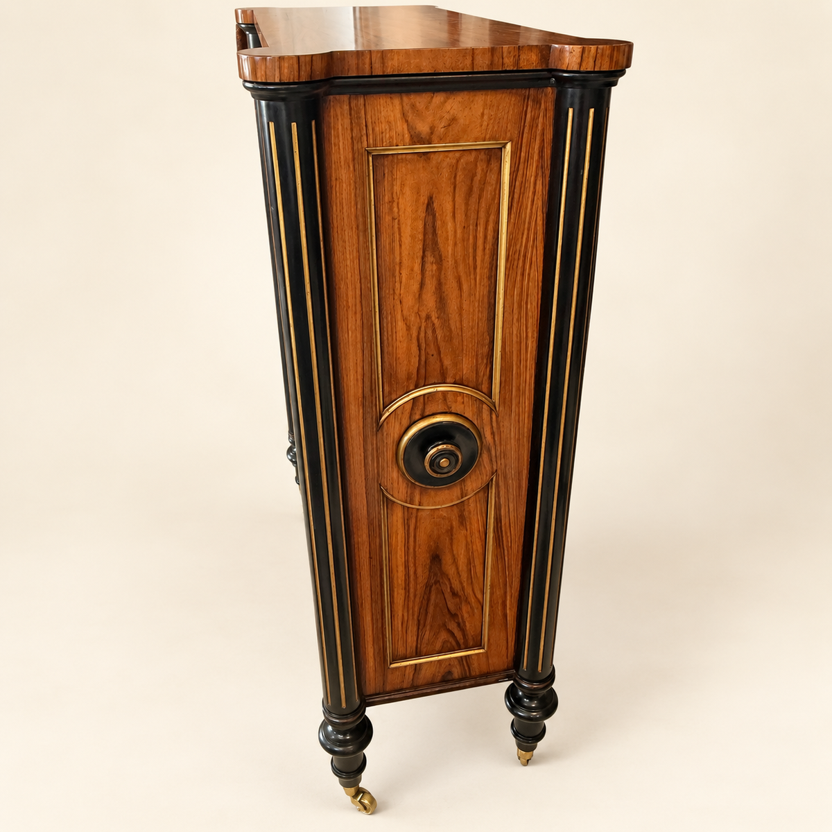 Side of Edwardian bookcase with rosewood panel, gilt border and turned roundel