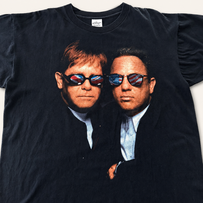 Elton John Billy Joel 1994 all-over-print tee front, big portrait in American and UK flag sunglasses