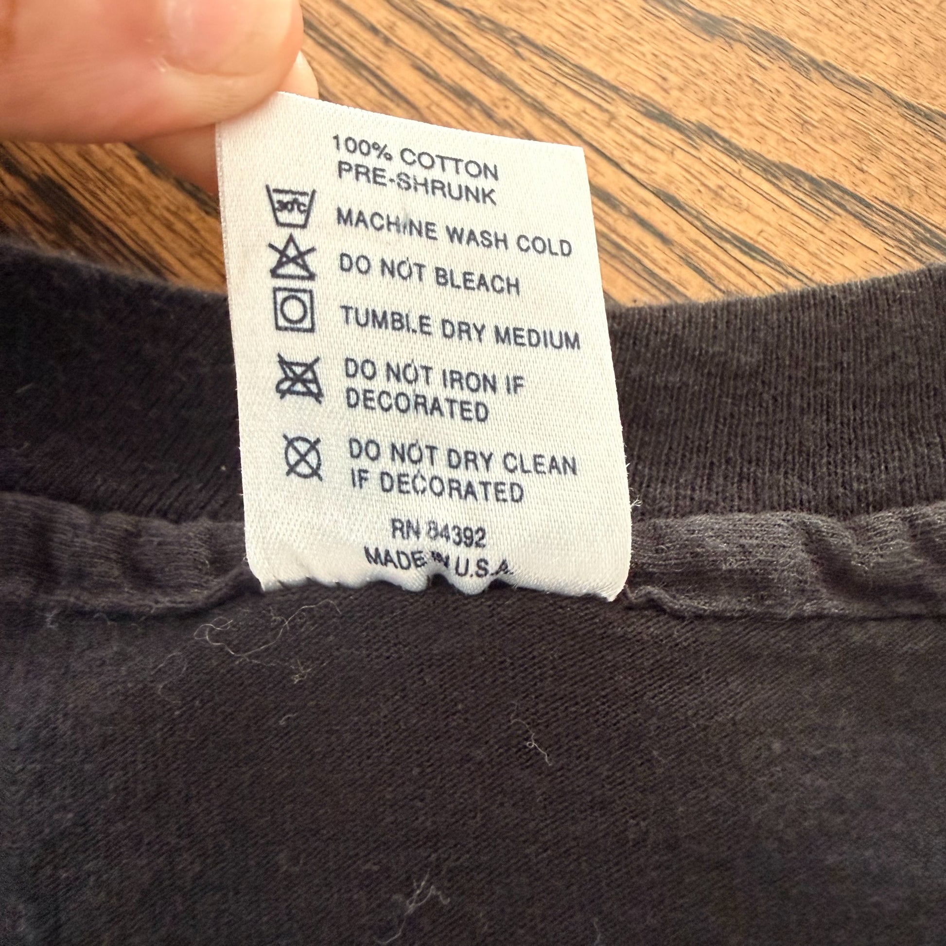 Care tag reading 100% cotton, Made in USA, RN 84392 — vintage 1994 tour t-shirt