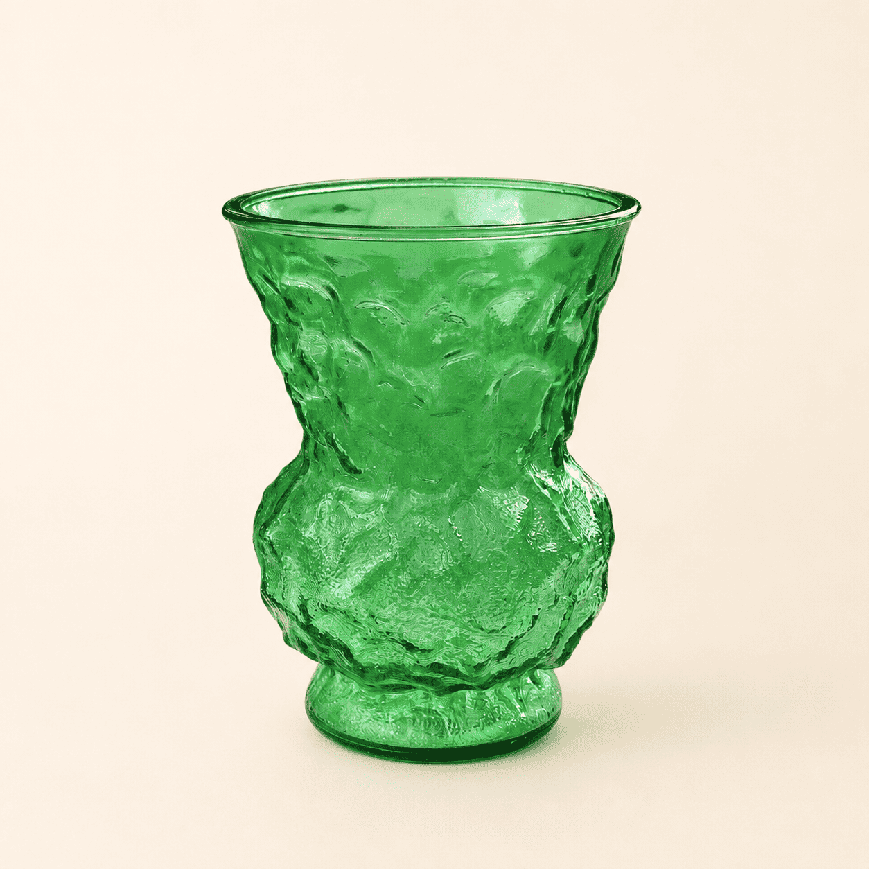 Angled view of vintage emerald green crinkle glass vase