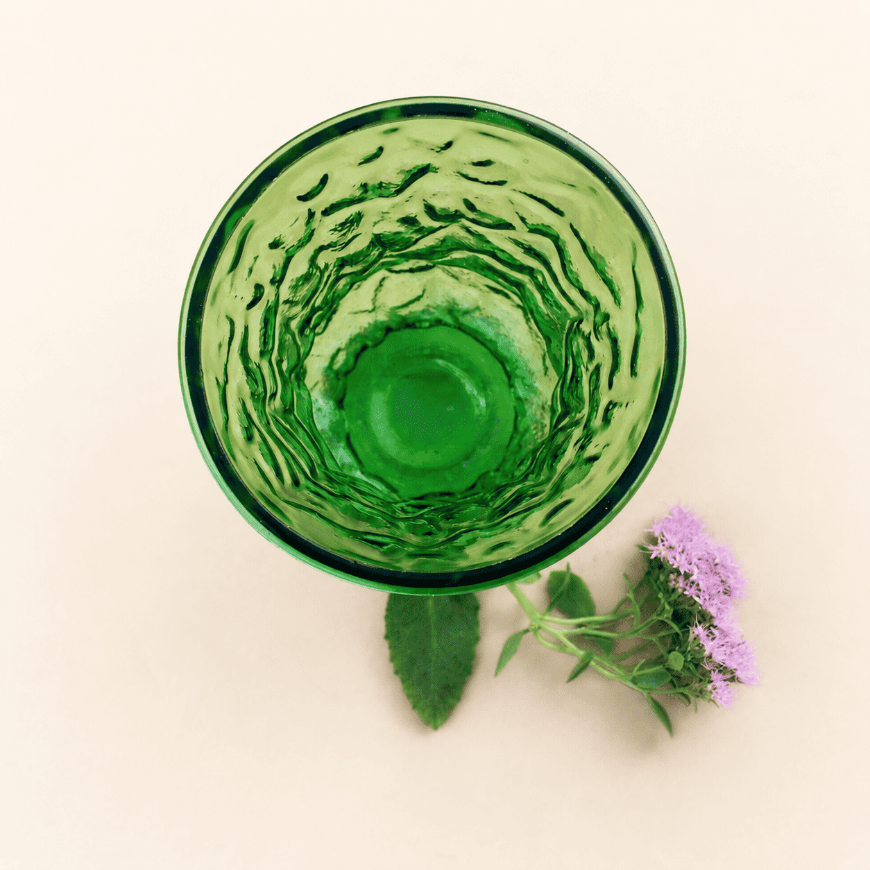 Top-down view into green crinkle glass vase showing textured interior