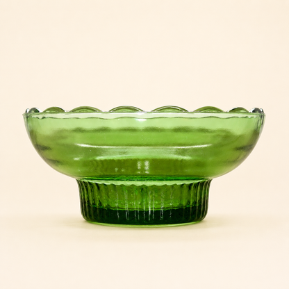 Side profile of E.O. Brody green glass pedestal bowl with reeded foot