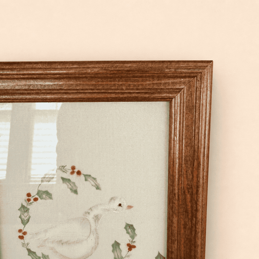Corner of oak frame with goose artwork