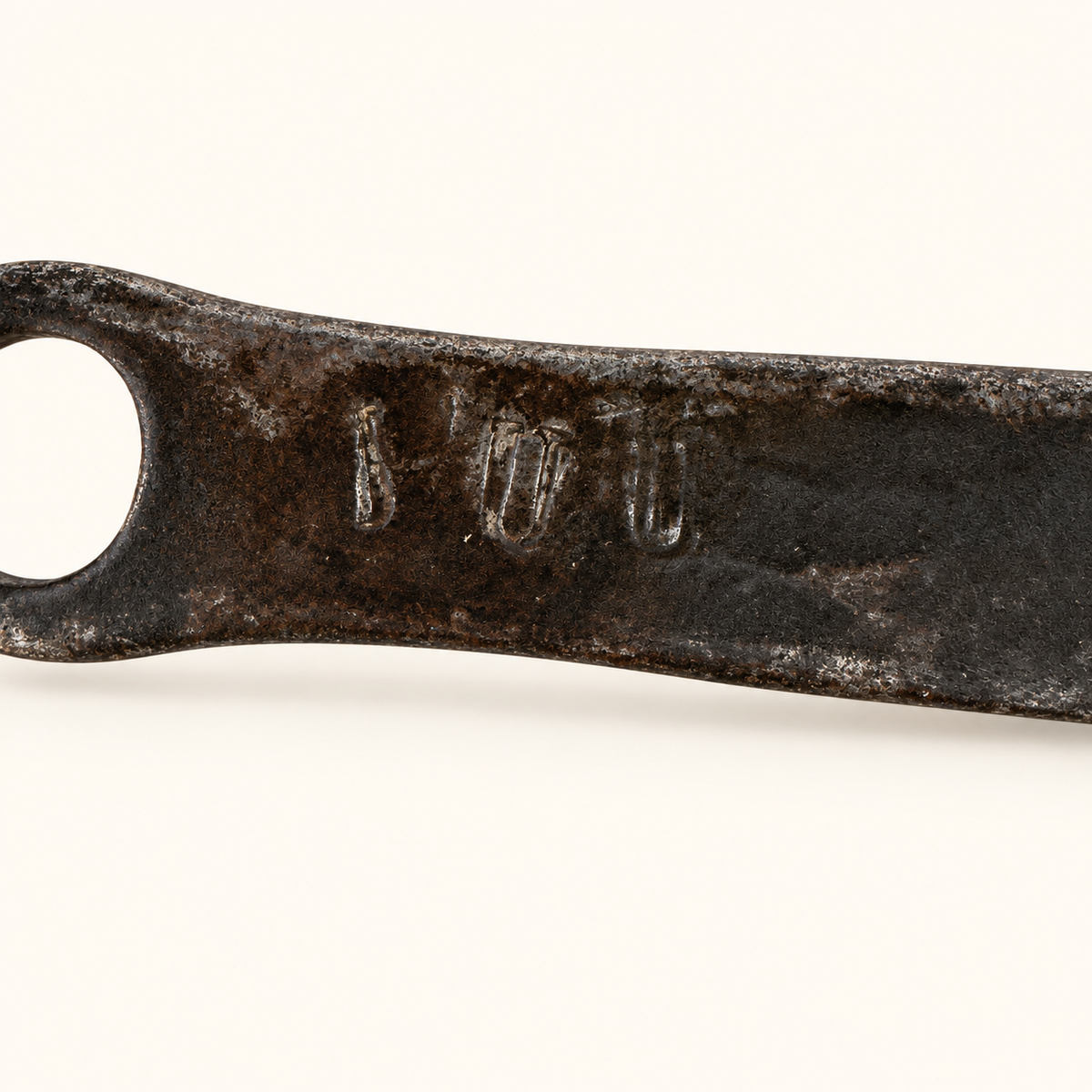 Stamped touchmarks on the forged iron handle near the hanging eye