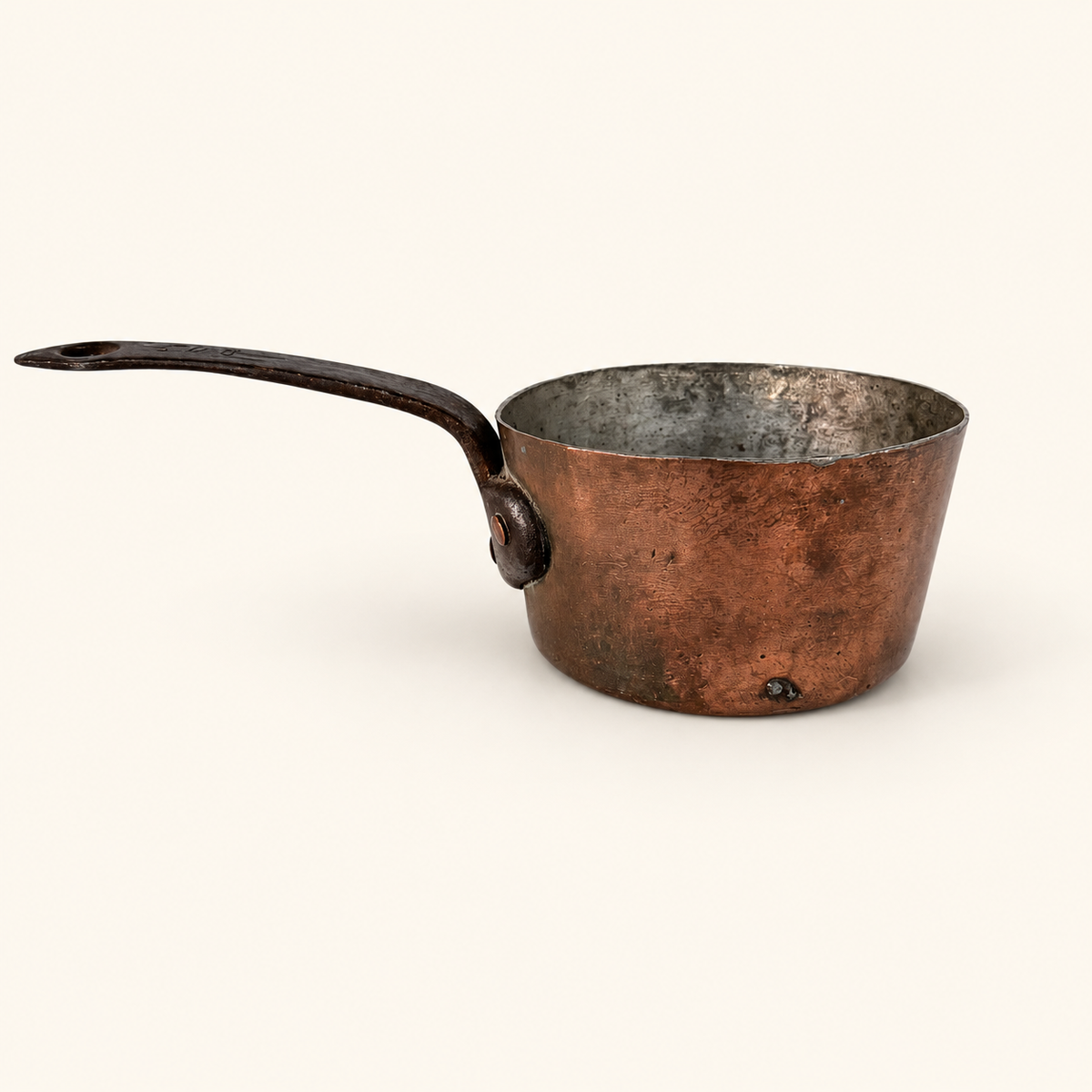 Antique French copper saucepan in profile, tin-lined with a forged iron handle