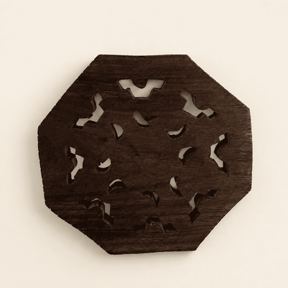 Back view of the carved wood trivet showing the rose-and-leaf pattern