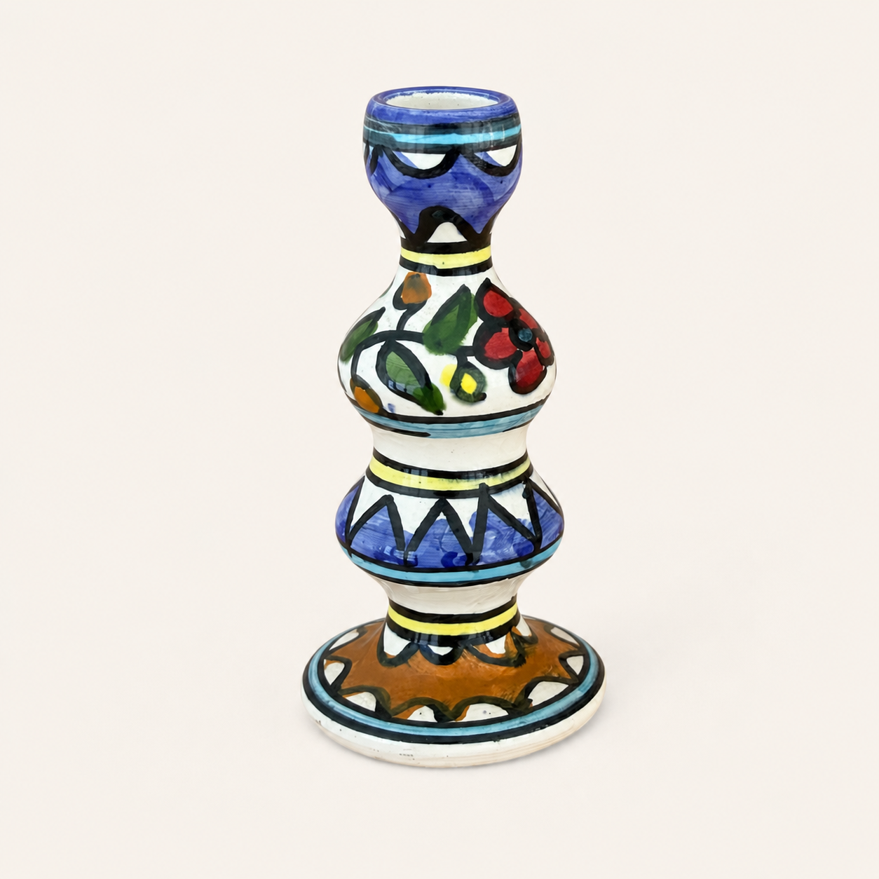 Hand-painted ceramic candlestick with cobalt, floral, and geometric folk pattern, front view