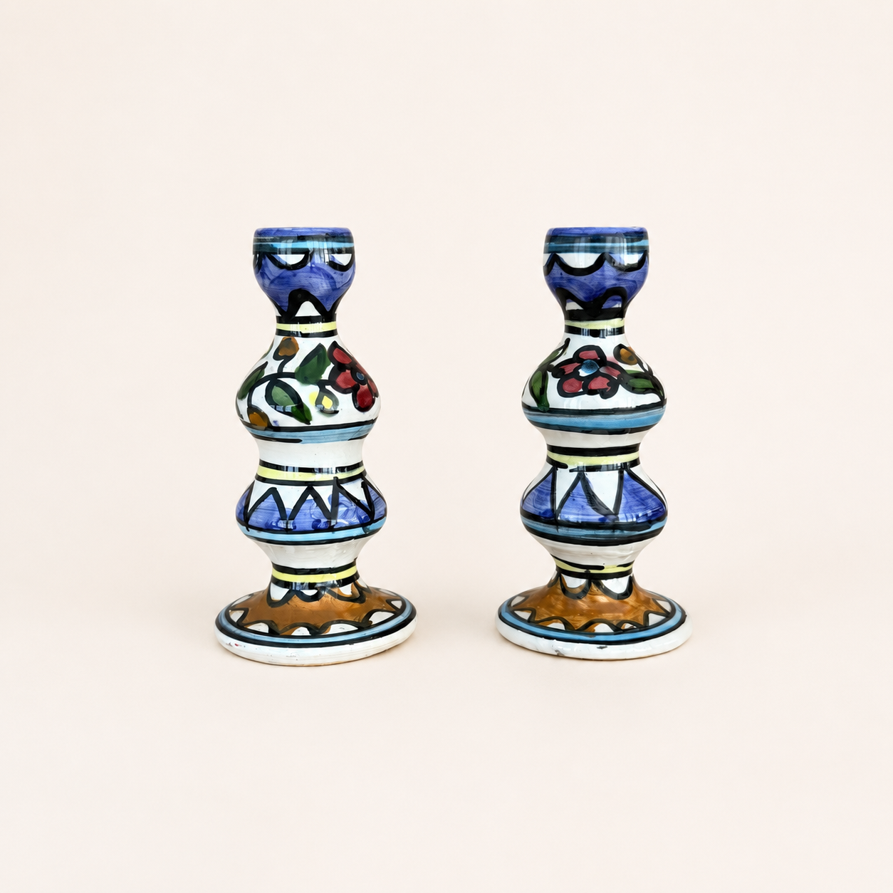 Pair of hand-painted ceramic candlesticks with floral and zigzag pattern, front view