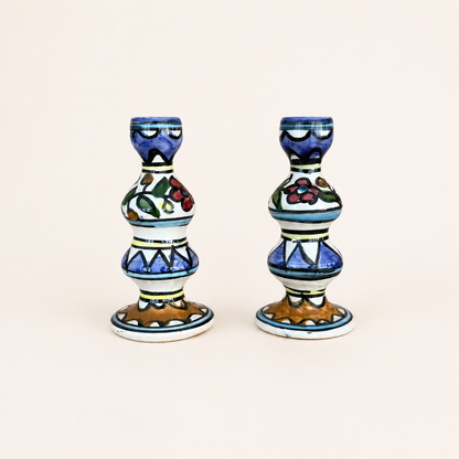 Pair of hand-painted ceramic candlesticks with floral and zigzag pattern, front view