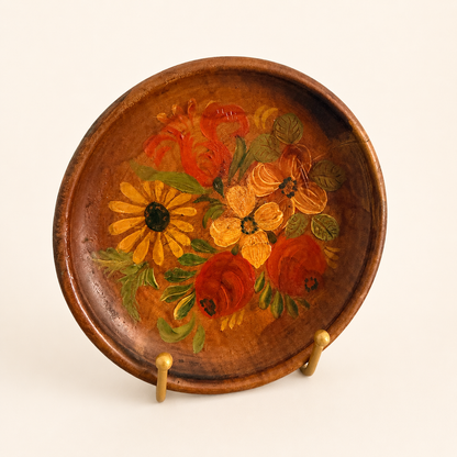 Angled view of hand-painted tole-style floral wood plate
