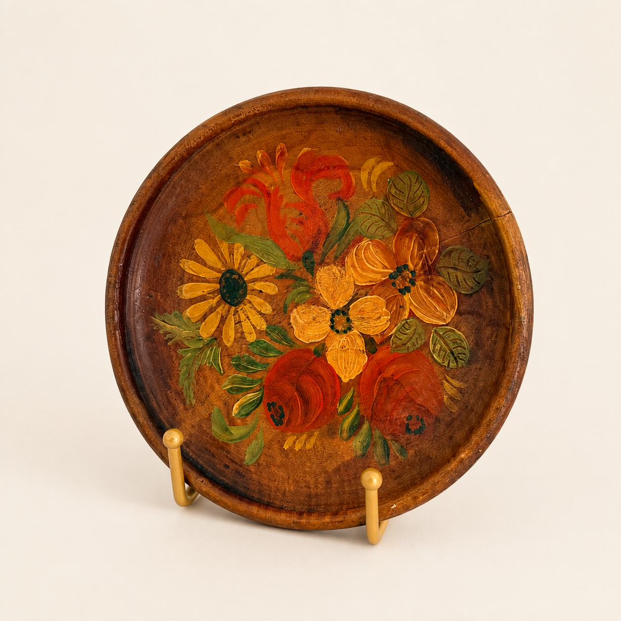 Hand-painted folk floral wooden plate displayed upright on a stand