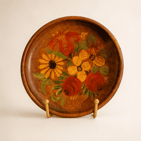 Hand-painted folk floral wood plate with roses and daisy bouquet, front view on stand