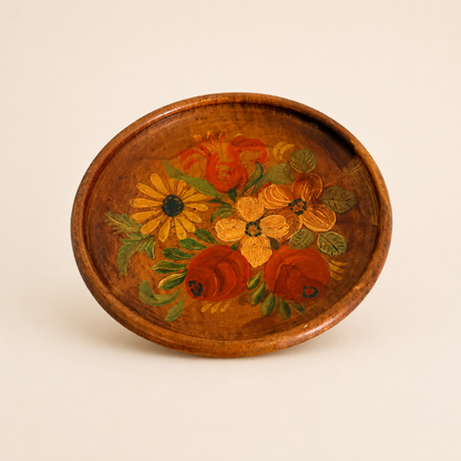 Overhead view of hand-painted floral wood plate showing full bouquet